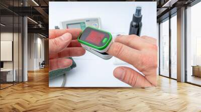 Pulse Oximeter, finger digital device to measure person`s oxygen saturation. Reduced oxygenation is an emergency sign of pneumonia. Prevention and diagnosis of mers covid 19 Wall mural